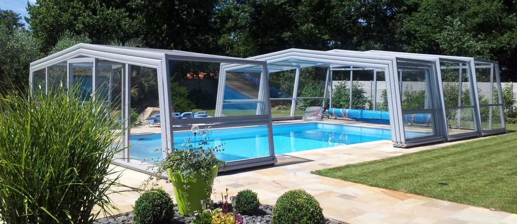 Abri de piscine haut télescopique installé dans un jardin dans le Var par ATOLL